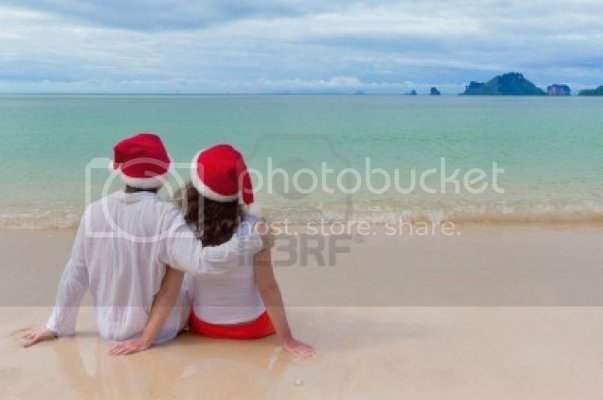 omantic-couple-in-santa-hats-on-beach1_zpsf6e83026.jpg